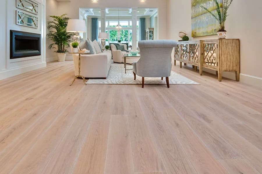 Modern living room with light wood flooring, stylish furniture, and bright natural lighting.